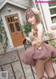 A woman in a brown dress is posing for a picture.